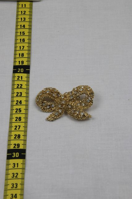 Broche nœud dorée à strass
